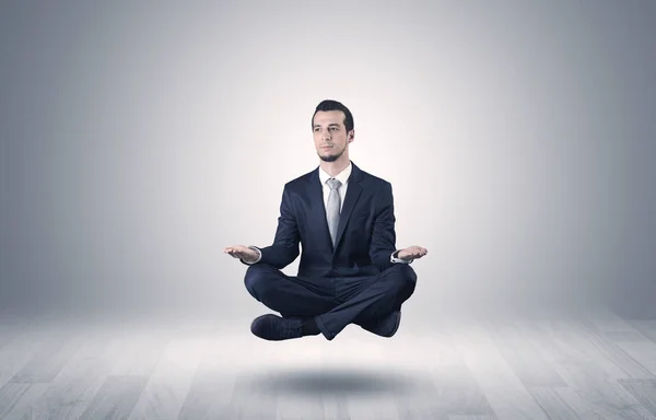 Businessman meditates in an empty space concept — Stock Photo, Image