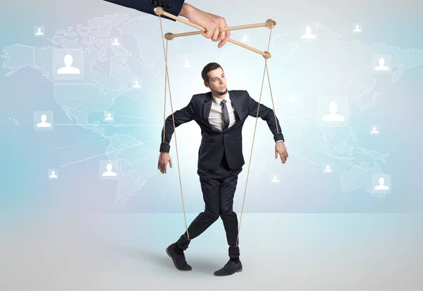 Little businessman controlled from above by another big hand — Stock Photo, Image