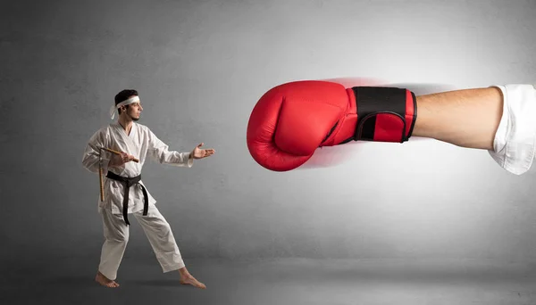 Malý muž bojuje s velkým červeným Boxerské rukavice — Stock fotografie