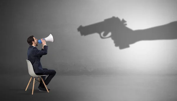 Businessman staying and offering stuffs for an armed shadow hand — Stock Photo, Image