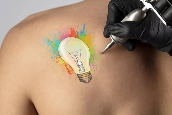 Tattooing idea concept on naked back
