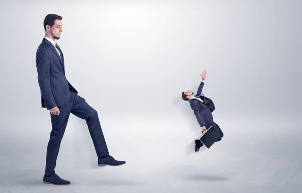 Small man fired by boss with white wallpaper — Stock Photo, Image