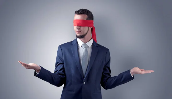 Covered eye businessman in front of a wall — Stock Photo, Image