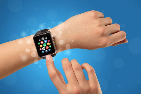 Female hand with smartwatch and app icons — Stock Photo, Image