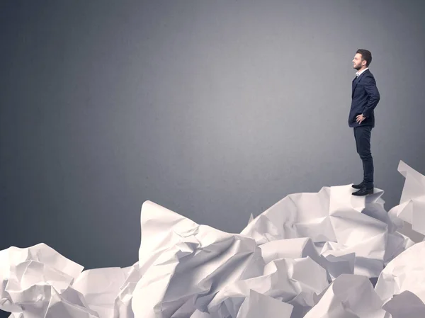 Businessman standing on crumpled paper — Stock Photo, Image