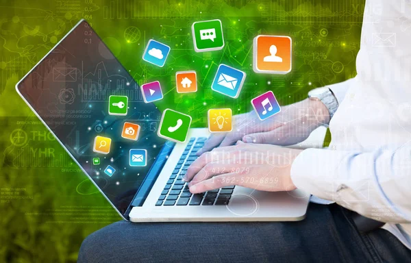 Hand mit Laptop mit hüpfenden Anwendungsdiagrammen und Berichtskonzept — Stockfoto