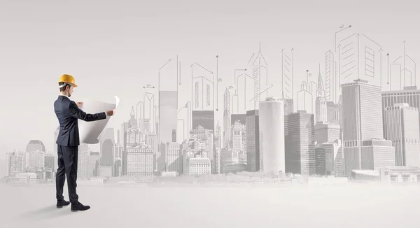 Architect standing and  replanning a city panorama — Stock Photo, Image