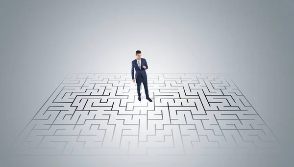 Businessman standing in a middle of a maze — Stock Photo, Image