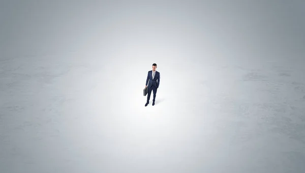 Businessman standing in the middle of an empty space — Stock Photo, Image