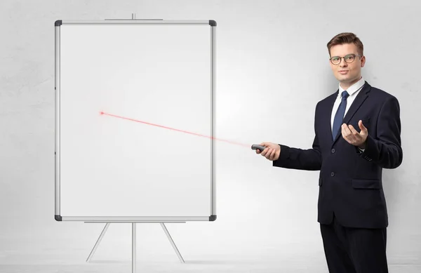 Businessman with laser pointer and copyspace white blackboard — Stock Photo, Image