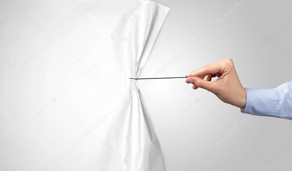 hand pulling white paper curtain