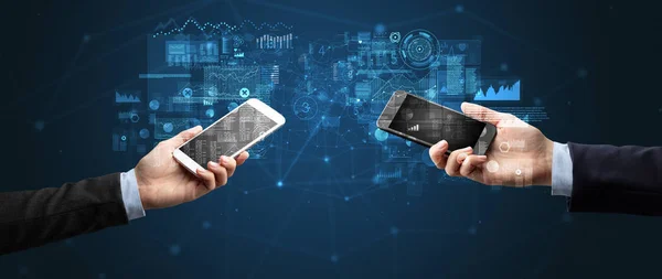 Deux mains tenant des smartphones pour synchroniser les données professionnelles — Photo