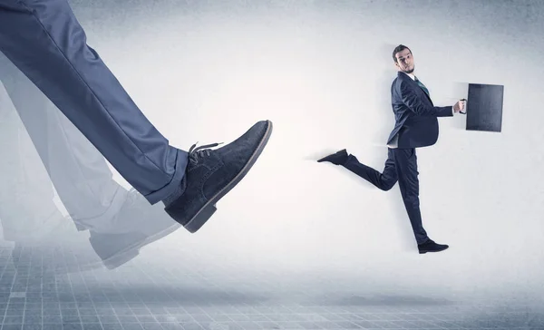 Businessman foot kicking small businessman — Stock Photo, Image