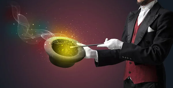 Illusionist hand making trick with wand — Stock Photo, Image