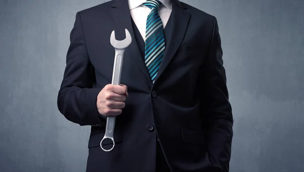 Businesman standing with tool on his hand — Stock Photo, Image