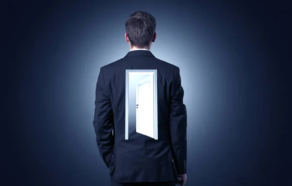 Businessman standing with door on his back — Stock Photo, Image