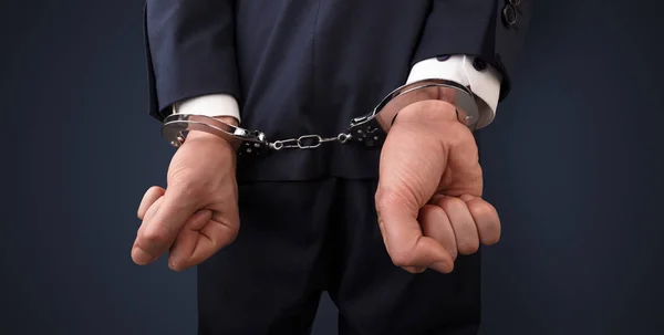 Dark backgrounded close handcuffed man — Stock Photo, Image