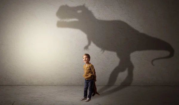 Dinosaurus shadow behind cute boy — Stock Photo, Image