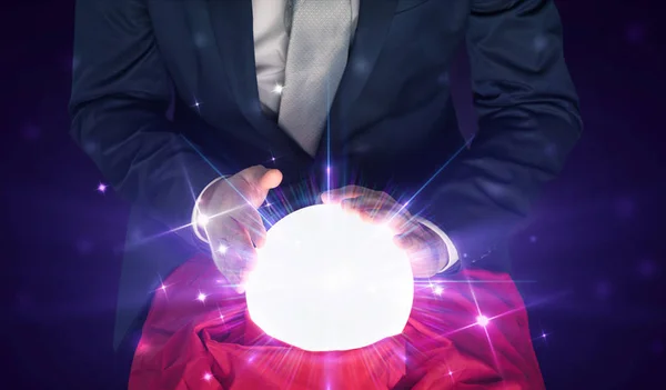 Businessman sitting with crystal ball in action — Stock Photo, Image