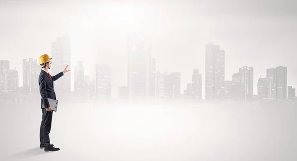 Architect standing and  looking at a big city panorama — Stock Photo, Image