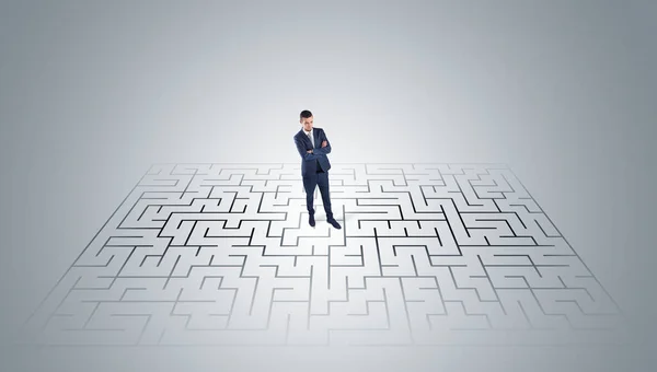 Businessman standing in a middle of a maze — Stock Photo, Image