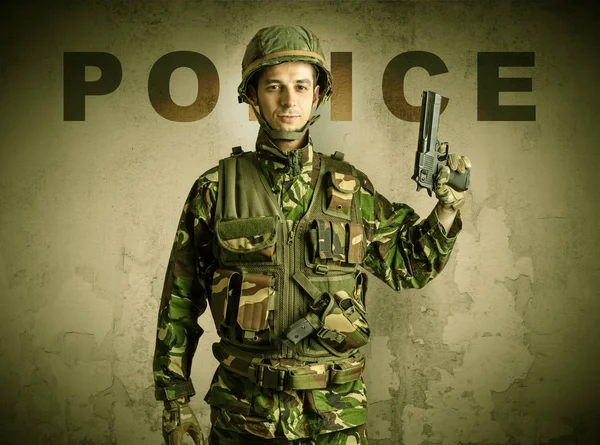 Armed soldier with damaged wall background — Stock Photo, Image