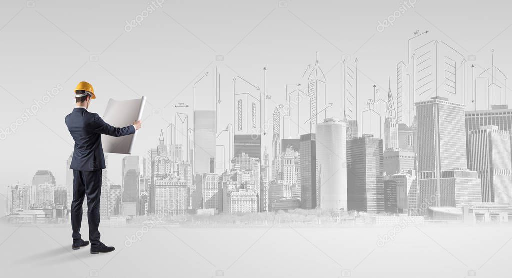 Architect standing and  replanning a city panorama