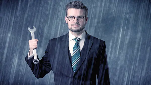 Employer standing with tool on his hand — Stock Photo, Image