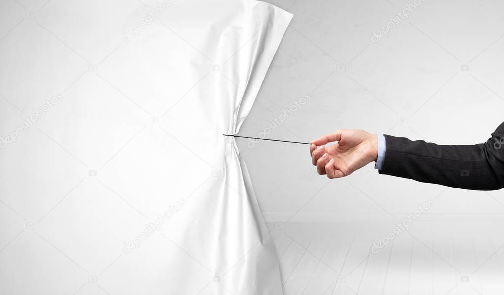 hand pulling white paper curtain