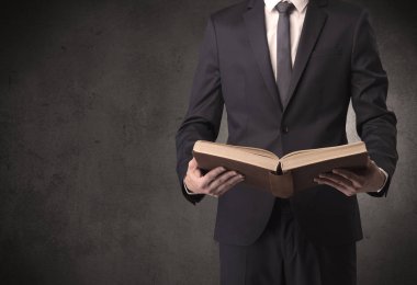 Elinde kitap tutan bir işadamı.