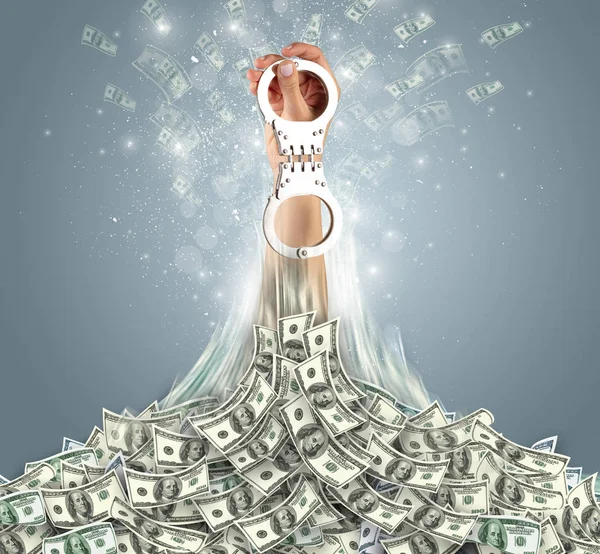 Hand bursting out from a money heap — Stock Photo, Image