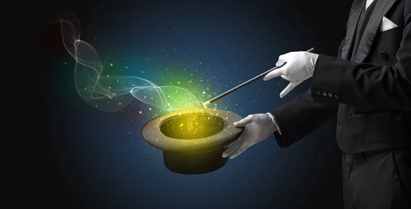 Illusionist hand making trick with wand — Stock Photo, Image