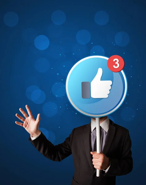 Businessman holding facebook sign — Stock Photo, Image