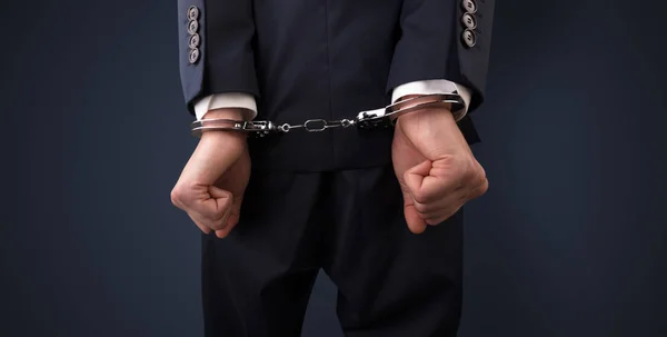 Dark backgrounded close handcuffed man — Stock Photo, Image