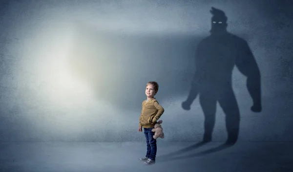 Cute kid with hero shadow behind — Stock Photo, Image