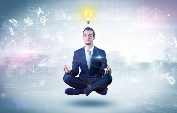 Businessman meditates with enlightenment concept — Stock Photo, Image