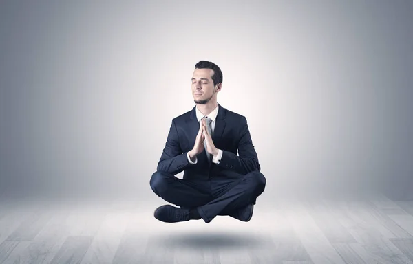 Businessman meditates in an empty space concept — Stock Photo, Image