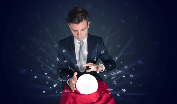 Businessman looking to inspiration in a magic ball and doodle concept — Stock Photo, Image