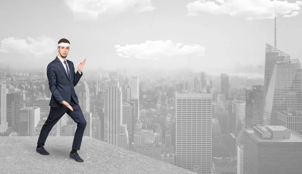 Suited karate man doing karate tricks on the top of a metropolitan city