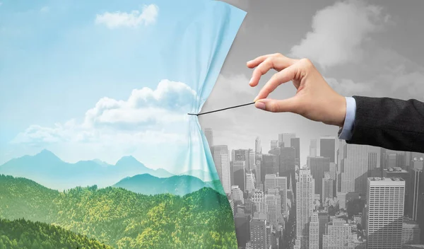 Hand pulling nature cityscape curtain to gray cityscape — Stock Photo, Image