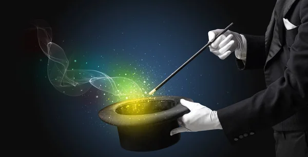 Illusionist hand making trick with wand — Stock Photo, Image