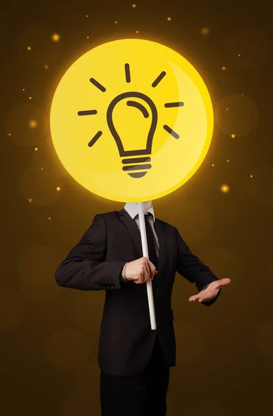 Businessman holding lightbulb sign — Stock Photo, Image