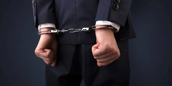 Dark backgrounded close handcuffed man — Stock Photo, Image