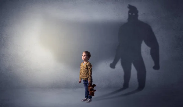 Cute kid with hero shadow behind — Stock Photo, Image