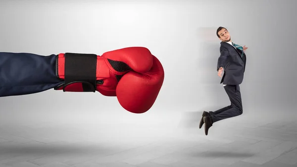 Mão gigante dá um chute a um pequeno empresário — Fotografia de Stock