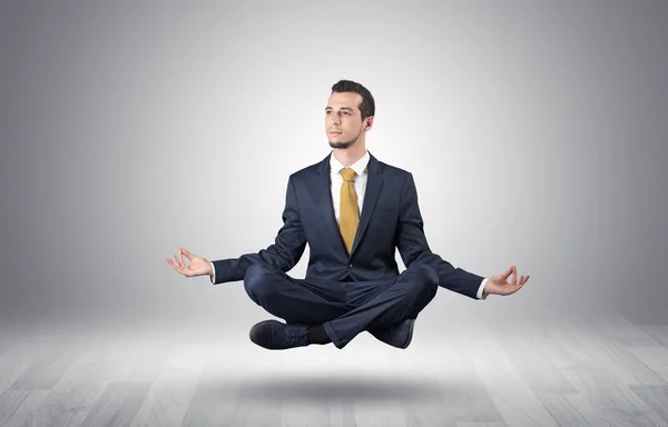 Businessman meditates in an empty space concept — Stock Photo, Image