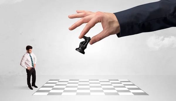 Kleiner Geschäftsmann spielt Schach mit einem großen Handkonzept — Stockfoto