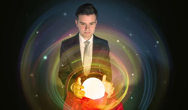 Man looking to the future of the word in a magic ball — Stock Photo, Image