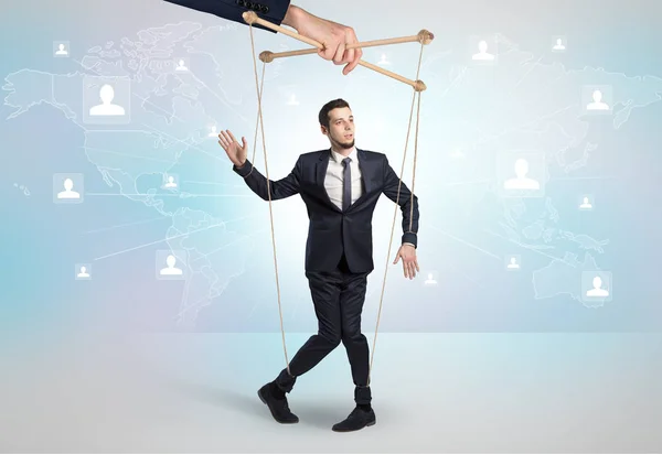 Little businessman controlled from above by another big hand — Stock Photo, Image