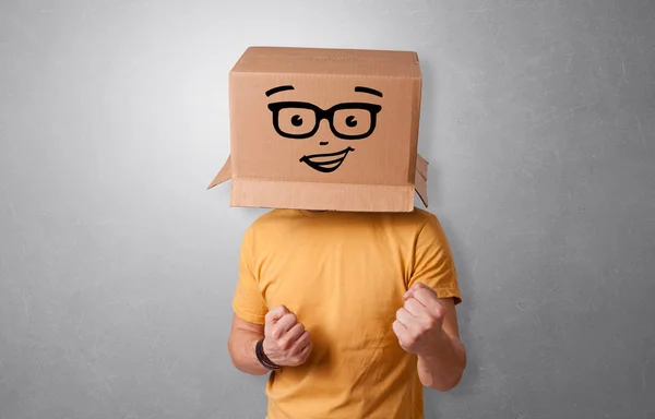 Young man  with happy cardboard box face — Stock Photo, Image